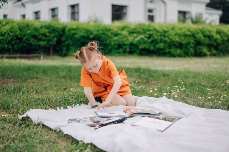 a girl reading books outdoors